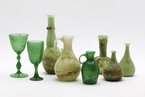 A collection of green glass bottles of different sizes and shapes. 